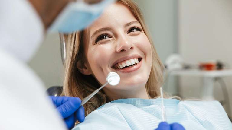 woman smiling after getting dental crowns in sandpoint